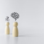 Wooden doll with brain icon. Businessperson or student or leader training skill improvement or development. Business knowledge and education learning success idea. Concept of leadership vision.
