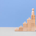 Wooden blocks in form of graphical steps up and wooden stars of business growth process, start-up, business goals management, sustainable financial plan. Action plan, profit, economic improvement concepts