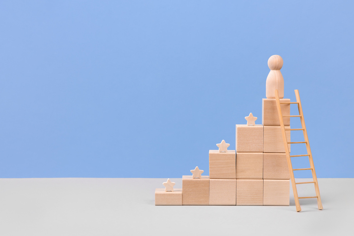 Wooden blocks in form of graphical steps up and wooden stars of business growth process, start-up, business goals management, sustainable financial plan. Action plan, profit, economic improvement concepts