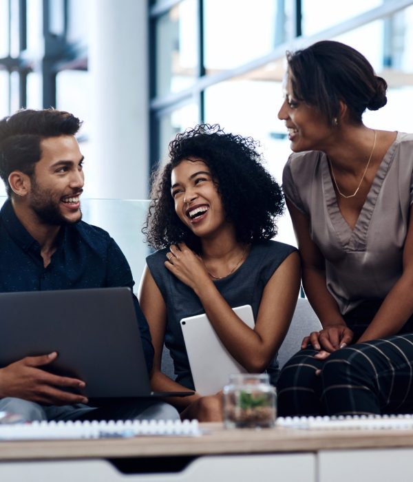 Shot of a group of young businesspeople planning and discussing ideas together in the lounge area at work